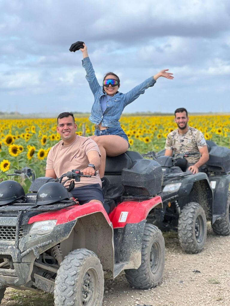 Group riding ATVs at sunset